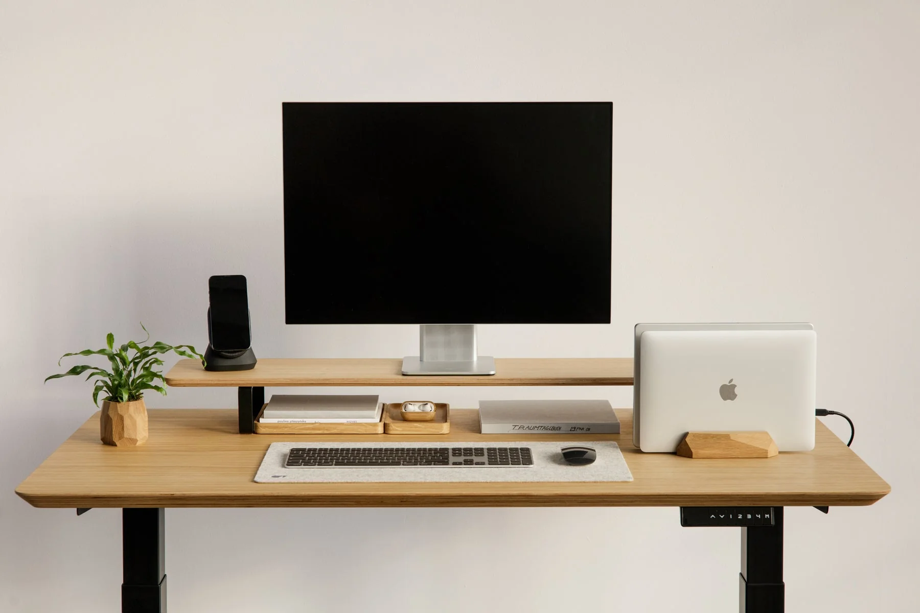 Calm desk with notebook, pen and a glass of water beside a softly lit window